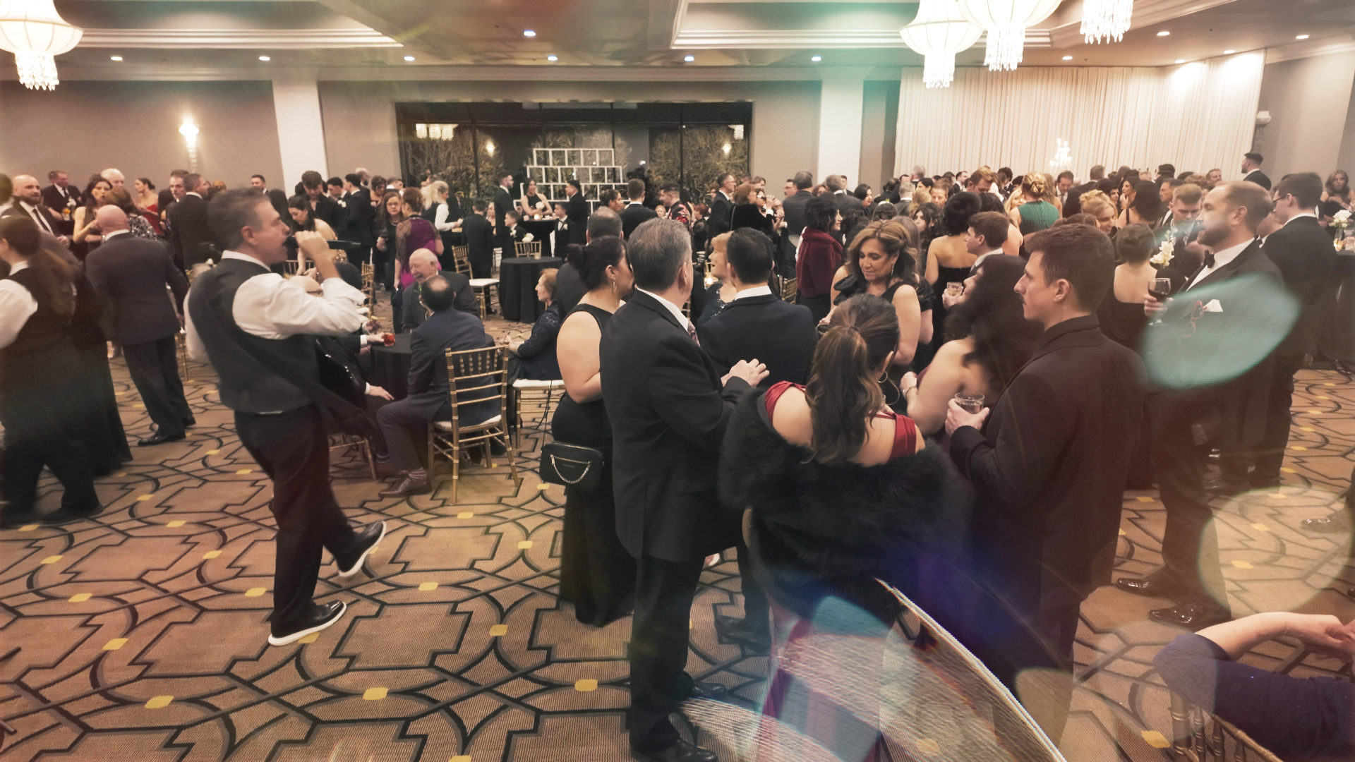 Crowded ballroom event with live music